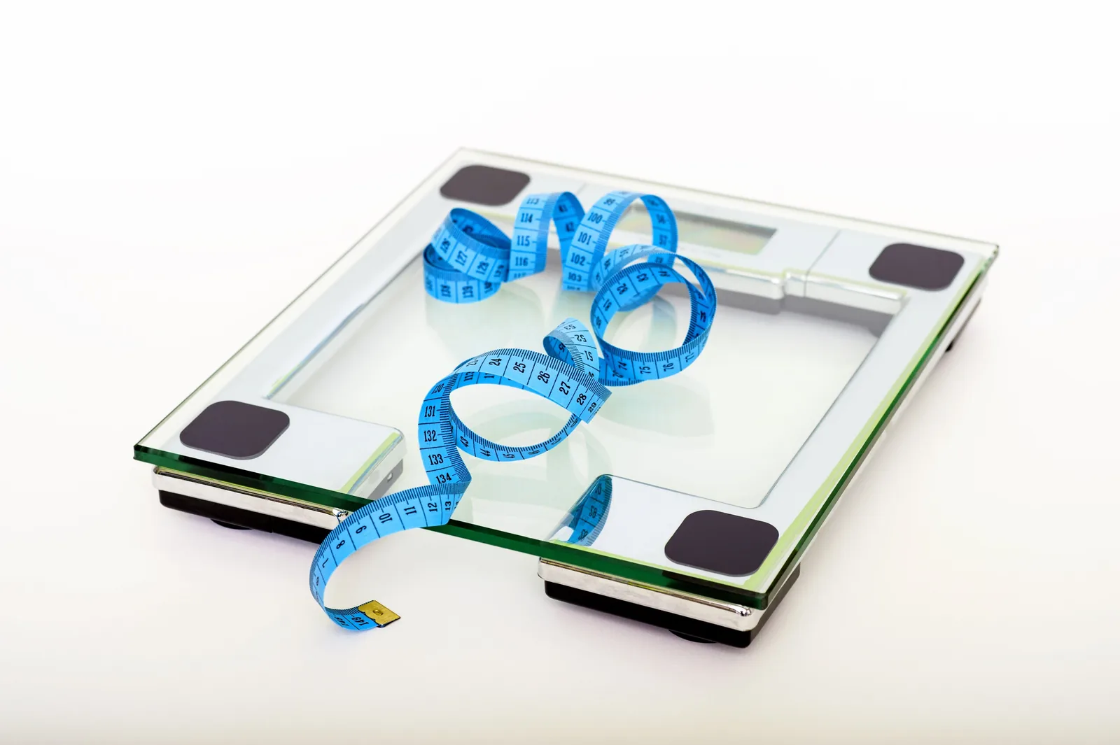 A bathroom scale with a tape measure